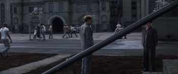 Movie still from “The Last Castle” (2001), directed by Rod Lurie – A man standing on the side of the street; Wide shot, High angle