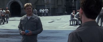 Movie still from “The Last Castle” (2001), directed by Rod Lurie – A man standing on the street in front of other people; Medium shot, Over the shoulder angle