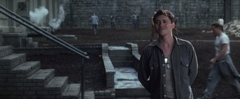 Movie still from “The Last Castle” (2001), directed by Rod Lurie – A man standing in front of a stone wall; Medium shot, Over the shoulder angle