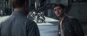 Movie still from “The Last Castle” (2001), directed by Rod Lurie – A man standing next to another man on the sidewalk; Close Up shot, Over the shoulder angle
