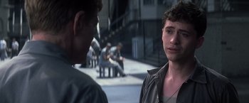Movie still from “The Last Castle” (2001), directed by Rod Lurie – Two young men sitting on the side of the street; Close Up shot, Over the shoulder angle