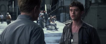 Movie still from “The Last Castle” (2001), directed by Rod Lurie – A man standing next to another man on a street; Close Up shot, Over the shoulder angle
