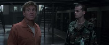 Movie still from “The Last Castle” (2001), directed by Rod Lurie – Two men standing next to each other in a building; Medium shot, Over the shoulder angle