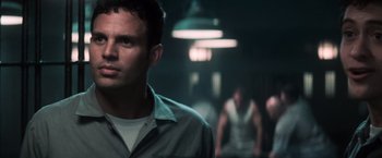 Movie still from “The Last Castle” (2001), directed by Rod Lurie – A man standing in a dark room next to two other men; Close Up shot, Low angle