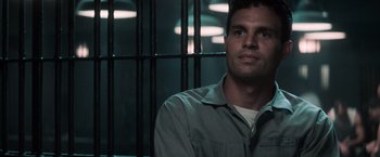 Movie still from “The Last Castle” (2001), directed by Rod Lurie – A man sitting in front of a metal cage; Close Up shot, Low angle