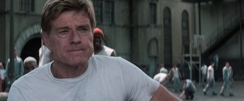 Movie still from “The Last Castle” (2001), directed by Rod Lurie – A person wearing a white t - shirt; Close Up shot, Low angle