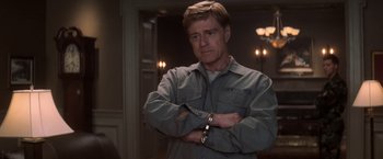 Movie still from “The Last Castle” (2001), directed by Rod Lurie – A man with his arms crossed in a room; Medium shot, Over the shoulder angle
