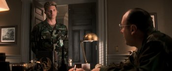 Movie still from “The Last Castle” (2001), directed by Rod Lurie – A man in military fatigues standing in front of a mirror; Medium shot, Over the shoulder angle