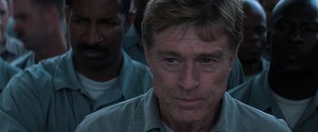 Movie still from “The Last Castle” (2001), directed by Rod Lurie – A person wearing a green shirt; Close Up shot, Over the shoulder angle