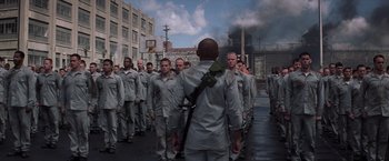 Movie still from “The Last Castle” (2001), directed by Rod Lurie – A group of men in grey uniforms are standing in a row; Wide shot, High angle