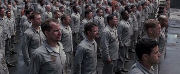 Movie still from “The Last Castle” (2001), directed by Rod Lurie – A large group of men standing in a row; Wide shot, High angle