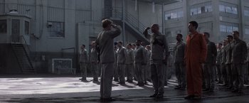 Movie still from “The Last Castle” (2001), directed by Rod Lurie – A group of men standing next to each other in a building; Wide shot, Low angle