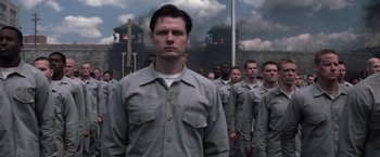 Movie still from “The Last Castle” (2001), directed by Rod Lurie – A group of men standing next to each other in uniforms; Medium shot, Low angle