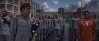 Movie still from “The Last Castle” (2001), directed by Rod Lurie – A group of men in uniform marching down a street; Wide shot, High angle