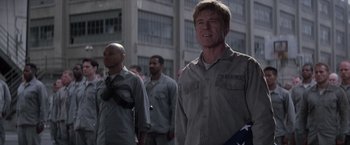 Movie still from “The Last Castle” (2001), directed by Rod Lurie – A group of men standing next to each other on a street; Medium shot, Low angle