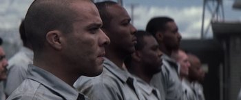 Movie still from “The Last Castle” (2001), directed by Rod Lurie – A group of men standing next to each other in a row; Close Up shot, Low angle