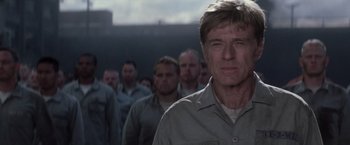 Movie still from “The Last Castle” (2001), directed by Rod Lurie – A group of men standing next to each other in front of a building; Close Up shot, Low angle
