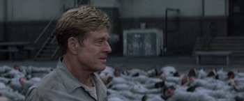 Movie still from “The Last Castle” (2001), directed by Rod Lurie – A person standing in front of a group of people; Close Up shot, Over the shoulder angle