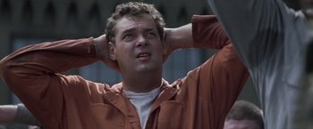 Movie still from “The Last Castle” (2001), directed by Rod Lurie – A person holding his hands behind his head; Close Up shot, Low angle