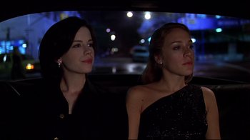 Movie still from “The Last Days of Disco” (1998), directed by Whit Stillman – Two women sitting in the back seat of a car at night; Medium shot, Low angle