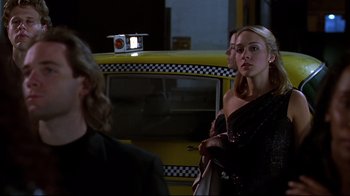 Movie still from “The Last Days of Disco” (1998), directed by Whit Stillman – A woman standing next to a yellow taxi cab; Medium shot, Over the shoulder angle