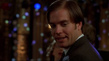 Movie still from “The Last Days of Disco” (1998), directed by Whit Stillman – A man in a suit and tie looking at the camera; Close Up shot, Over the shoulder angle
