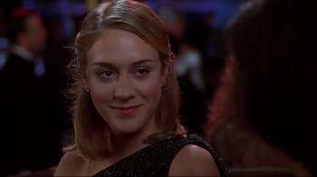 Movie still from “The Last Days of Disco” (1998), directed by Whit Stillman – A person wearing a dress; Close Up shot, Over the shoulder angle
