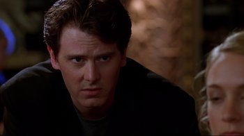 Movie still from “The Last Days of Disco” (1998), directed by Whit Stillman – A person wearing a black jacket; Close Up shot, Low angle