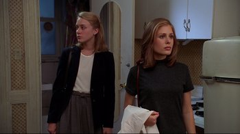 Movie still from “The Last Days of Disco” (1998), directed by Whit Stillman – Two young women standing next to each other in front of a mirror; Medium shot, Over the shoulder angle
