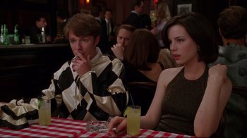 Movie still from “The Last Days of Disco” (1998), directed by Whit Stillman – A man and a woman sitting at a table with a drink; Medium shot, Over the shoulder angle