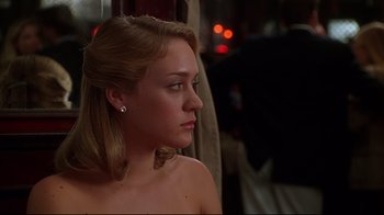 Movie still from “The Last Days of Disco” (1998), directed by Whit Stillman – A beautiful young lady looking off into the distance; Close Up shot, Over the shoulder angle