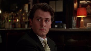 Movie still from “The Last Days of Disco” (1998), directed by Whit Stillman – A person wearing a suit and tie; Close Up shot, Low angle