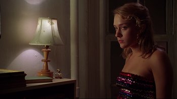 Movie still from “The Last Days of Disco” (1998), directed by Whit Stillman – A woman in a red dress looking at a table lamp; Medium shot, Low angle