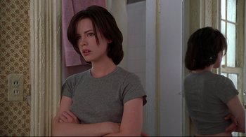 Movie still from “The Last Days of Disco” (1998), directed by Whit Stillman – A woman sitting in front of a bathroom mirror; Medium shot, Over the shoulder angle
