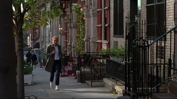 Movie still from “The Last Days of Disco” (1998), directed by Whit Stillman – A woman walking down the sidewalk of a city street; Wide shot, High angle