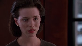 Movie still from “The Last Days of Disco” (1998), directed by Whit Stillman – A woman's face in a dark room; Close Up shot, Over the shoulder angle