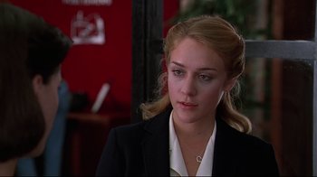 Movie still from “The Last Days of Disco” (1998), directed by Whit Stillman – A woman in a black jacket and a white shirt; Close Up shot, Over the shoulder angle