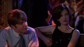 Movie still from “The Last Days of Disco” (1998), directed by Whit Stillman – A man and a woman sitting next to each other; Medium shot, Over the shoulder angle