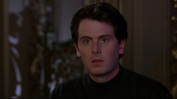 Movie still from “The Last Days of Disco” (1998), directed by Whit Stillman – A person wearing a black shirt; Close Up shot, Over the shoulder angle