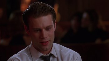 Movie still from “The Last Days of Disco” (1998), directed by Whit Stillman – A man in a white dress shirt and a tie; Close Up shot, Low angle