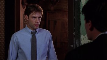 Movie still from “The Last Days of Disco” (1998), directed by Whit Stillman – A man wearing a blue dress shirt and a tie; Close Up shot, Over the shoulder angle