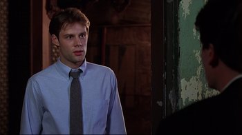 Movie still from “The Last Days of Disco” (1998), directed by Whit Stillman – A man wearing a blue dress shirt and a tie; Close Up shot, Over the shoulder angle