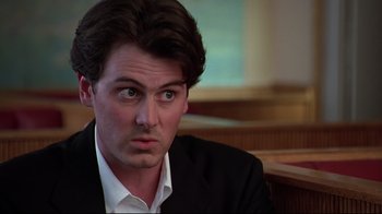 Movie still from “The Last Days of Disco” (1998), directed by Whit Stillman – A person wearing a suit and tie; Close Up shot, Low angle