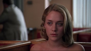 Movie still from “The Last Days of Disco” (1998), directed by Whit Stillman – A young woman sitting in front of a mirror; Close Up shot, Low angle