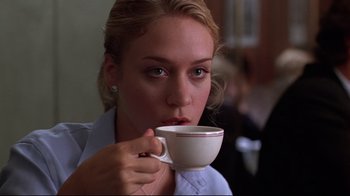 Movie still from “The Last Days of Disco” (1998), directed by Whit Stillman – A woman holding a coffee cup in her hand; Close Up shot, Low angle