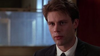 Movie still from “The Last Days of Disco” (1998), directed by Whit Stillman – A person wearing a suit and tie; Close Up shot, Low angle