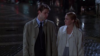 Movie still from “The Last Days of Disco” (1998), directed by Whit Stillman – A man and a woman standing next to each other; Medium shot, Over the shoulder angle