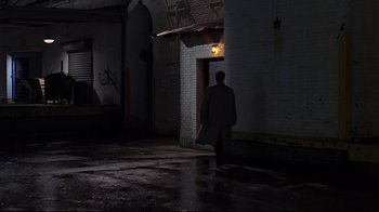 Movie still from “The Last Days of Disco” (1998), directed by Whit Stillman – A man walking in the dark in front of a building; Extreme Wide shot, High angle