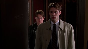Movie still from “The Last Days of Disco” (1998), directed by Whit Stillman – A man and a woman are standing next to each other; Medium shot, Over the shoulder angle