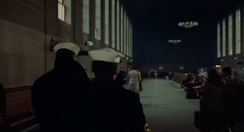 Movie still from “The Last Detail” (1973), directed by Hal Ashby – A couple of men in uniform are standing in the dark; Extreme Wide shot, Low angle